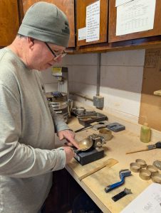 Technician performing soil testing in a construction materials laboratory using standard testing equipment