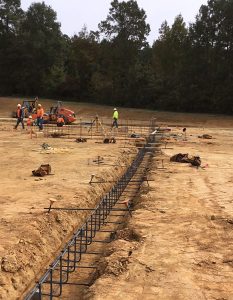 reinforcing steel rebar in footing trench before concrete placement during construction inspection