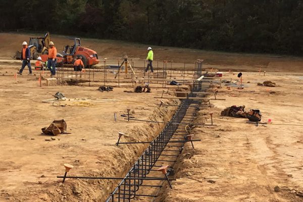 reinforcing steel rebar in footing trench before concrete placement during construction inspection