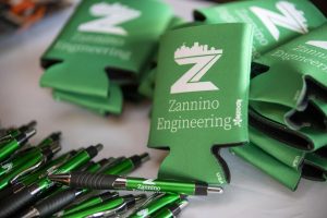Zannino Engineering branded pens and koozies displayed for guests at the company's 35th anniversary celebration.